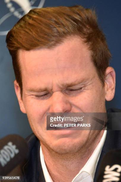 Australian cricketer Steve Smith reacts at a press conference at the airport in Sydney on March 29 after returning from South Africa. Distraught...