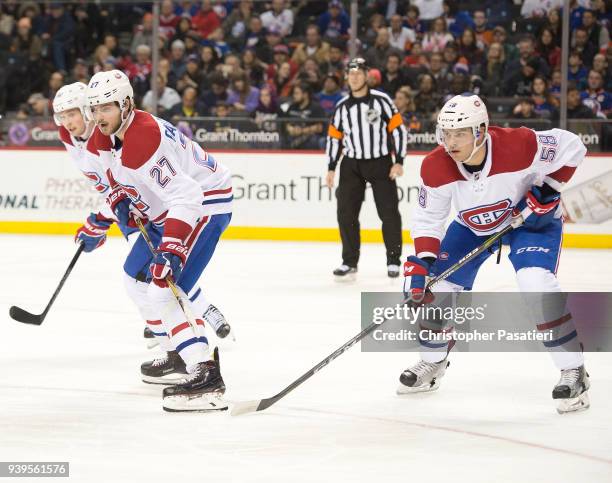 Alex Galchenyuk and Noah Juulsen of the Montreal Canadiens prepare for a face off during the third period against the New York Islanders at Barclays...