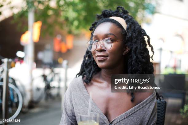 young woman sitting at street cafe - lilly roadstones stock pictures, royalty-free photos & images