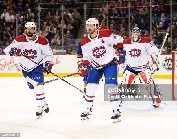 David Schlemko and Jeff Petry of the Montreal Canadiens skate during the third period against the New York Islanders at Barclays Center on March 2,...