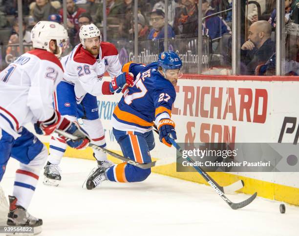 Anders Lee of the New York Islanders is checked from behind by Jeff Petry of the Montreal Canadiens during the third period at Barclays Center on...