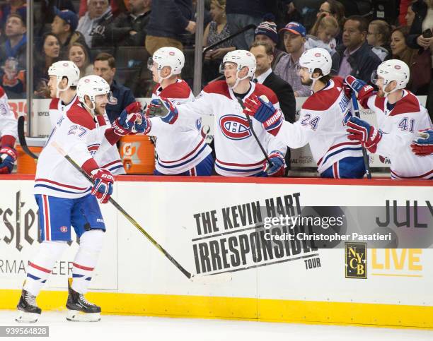 Alex Galchenyuk of the Montreal Canadiens is congratulated after scoring a third period goal against the New York Islanders at Barclays Center on...