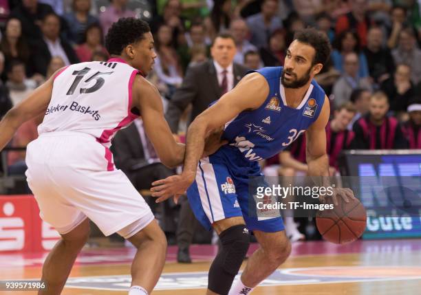 Malcolm Hill of Bonn and Philip Scrubb of Fraport Skyliners battle for the ball during the Basketball Bundesliga match between Telekom Baskets Bonn...