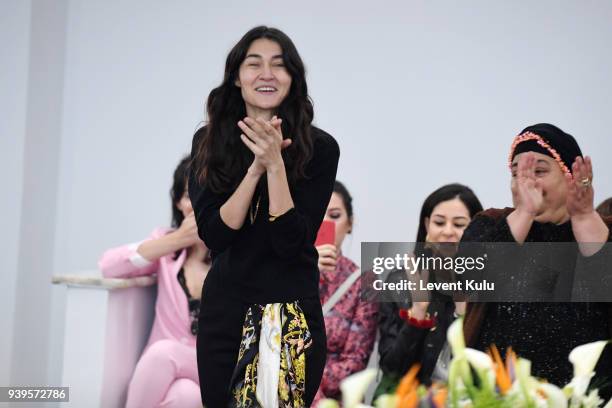 Designer Asli Filinta acknowledges the applause of the audience after her show during Mercedes Benz Fashion Week Istanbul at on March 29, 2018 in...