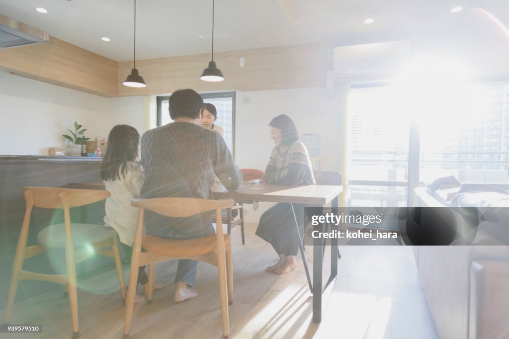 Family playing cards at home