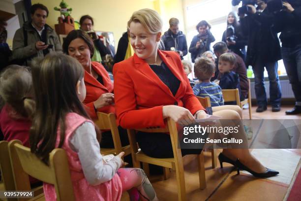 German Family Minister Franziska Giffey chats with children while visiting the "Abenteuerland" child daycare center on March 29, 2018 in Berlin,...