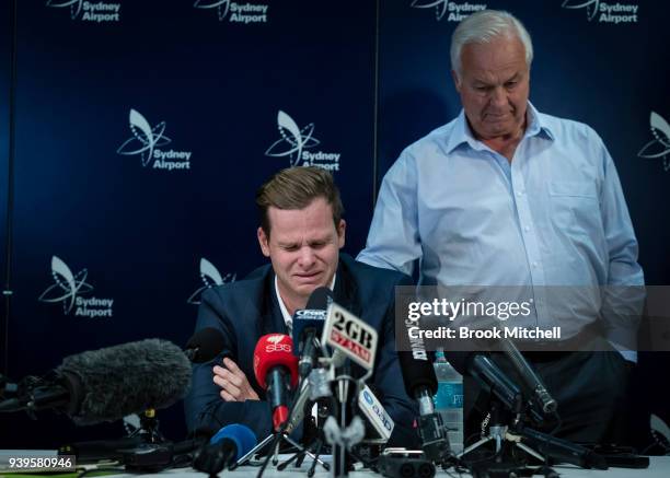 Australian Test cricketer Steve Smith is comforted by his father Peter as he confronts the media at Sydney International Airport on March 29, 2018 in...