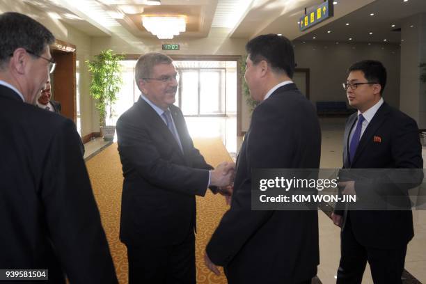 International Olympic Committee chief Thomas Bach shakes hands with Kim Il Guk , North Korea's Minister of Physical Culture and Sports who is also...