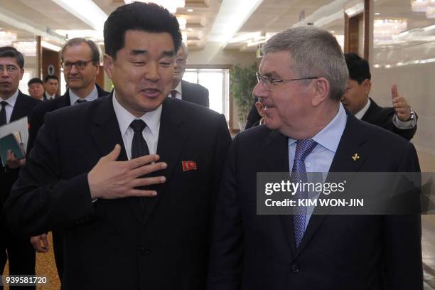 International Olympic Committee chief Thomas Bach speaks with Kim Il Guk, North Korea's Minister of Physical Culture and Sports who is also chairman...