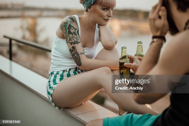 couple drinking beer on balcony - balcony party stock pictures, royalty-free photos & images