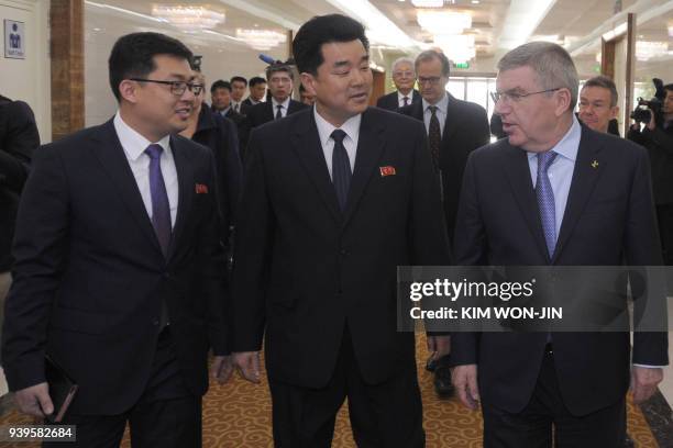 International Olympic Committee chief Thomas Bach speaks with Kim Il Guk , North Korea's Minister of Physical Culture and Sports who is also chairman...