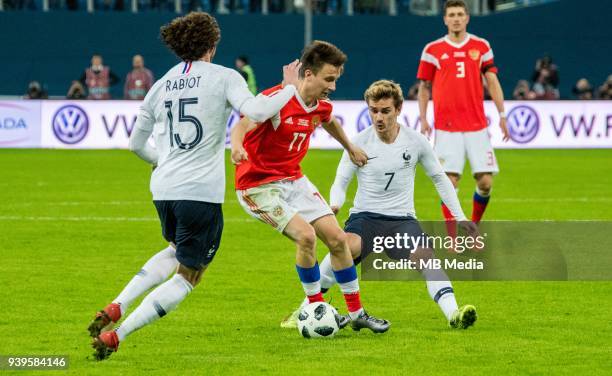 France's Adrien Rabiot , Russia's Aleksander Golovin and France's Antoine Griezmann fight for the ball during the International friendly football...