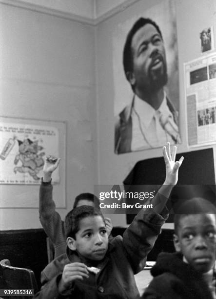 View of several young boys as they raise their hands during a free breakfast for children program sponsored by the Black Panther Party, New York, New...