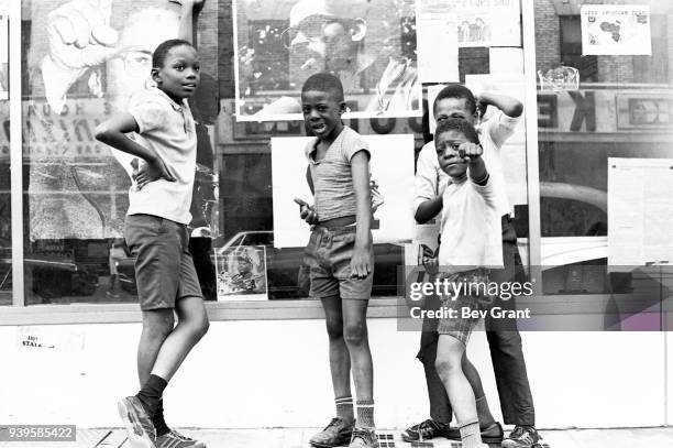 View of a group of unidentified boys as they stand in front of a window display at the Brooklyn Black Panther Party office , Brooklyn, New York, New...