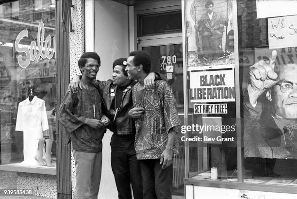 Black Panther Party Minister of Defense Joudan Ford shares a laugh with a pair of unidentified men in the doorway of the group's office , Brooklyn,...