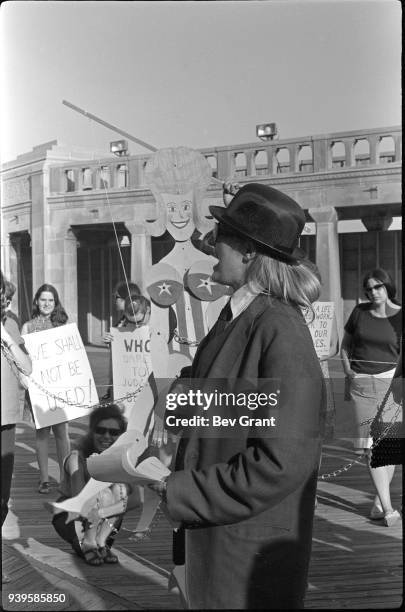 On the Atlantic City Boardwalk, demonstrator Peggy Dobbins 'auctions' a chained marionette during a protest of the Miss America beauty pageant,...