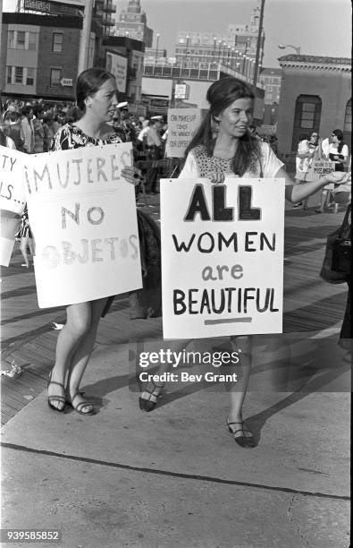 On the Atlantic City Boardwalk, demonstrators carry posters as they protest the Miss America beauty pageant, Atlantic City, New Jersey, September 7,...