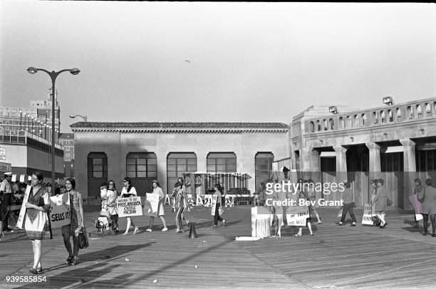 On the Atlantic City Boardwalk, demonstrators, many with posters, protest the Miss America beauty pageant, Atlantic City, New Jersey, September 7,...