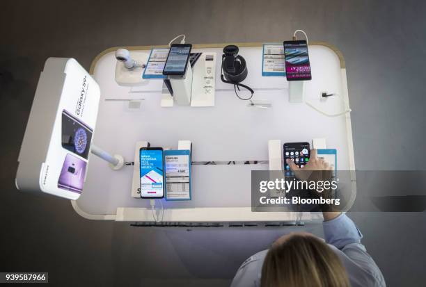 An employee demonstrates a Samsung Electronics Co. Galaxy S9+ inside a Telenor Serbia mobile phone store, operated by Telenor ASA, in Belgrade,...