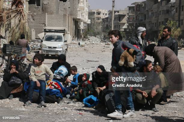 Syrian civilians wait to evacuate Eastern Ghouta to reach Hama province with convoy of vehicles due to Assad regime's assaults in Eastern Ghouta of...