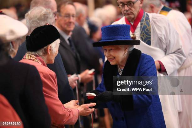 Queen Elizabeth II distributes the traditional Maundy money during the Royal Maundy service at St George's Chapel on March 29, 2018 in Windsor,...