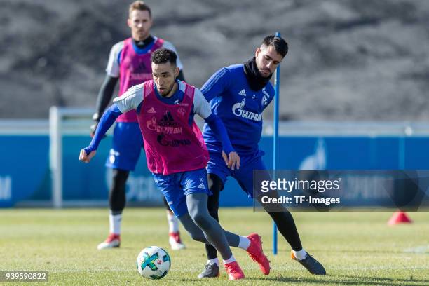 Nabil Bentaleb of Schalke and Pablo Insua of Schalke battle for the ball during a training session at the FC Schalke 04 Training center on March 26,...