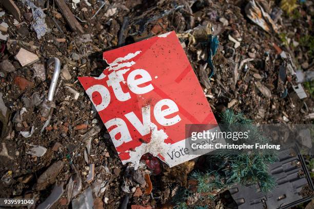 Today marks the one-year countdown to Brexit and a discarded and weather beaten 'Vote Leave' placard decays on a pile of rubbish next to the road in...