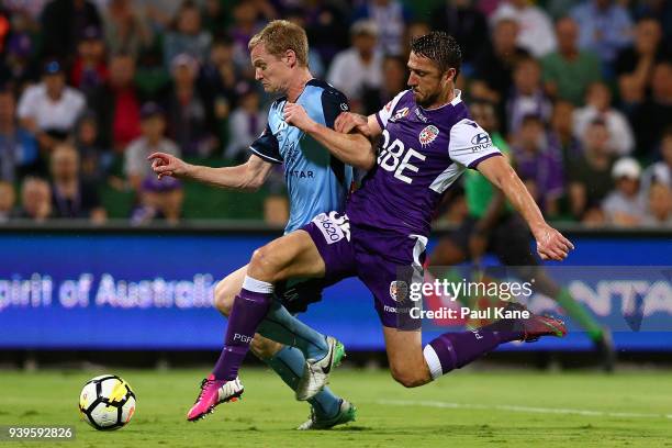 Dino Djulbic of the Glory tackles Matt Simon of Sydney during the round 25 A-League match between the Perth Glory and Sydney FC at nib Stadium on...