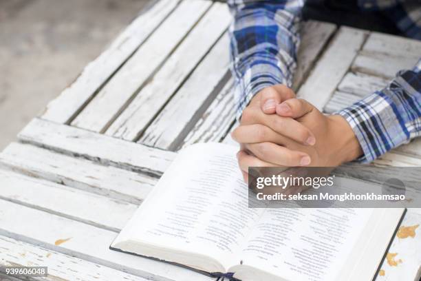 man reading from the holy bible, close up - bible cover stock pictures, royalty-free photos & images