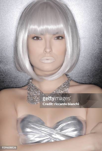portrait of woman with brown eyes white hair and silver futuristic dress - silver lipstick stock pictures, royalty-free photos & images