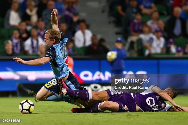 Dino Djulbic of the Glory tackles Matt Simon of Sydney during the round 25 A-League match between the Perth Glory and Sydney FC at nib Stadium on...