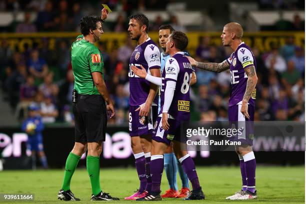 Referee Kris Griffiths-Jones shows Dino Djulbic of the Glory a yellow card during the round 25 A-League match between the Perth Glory and Sydney FC...