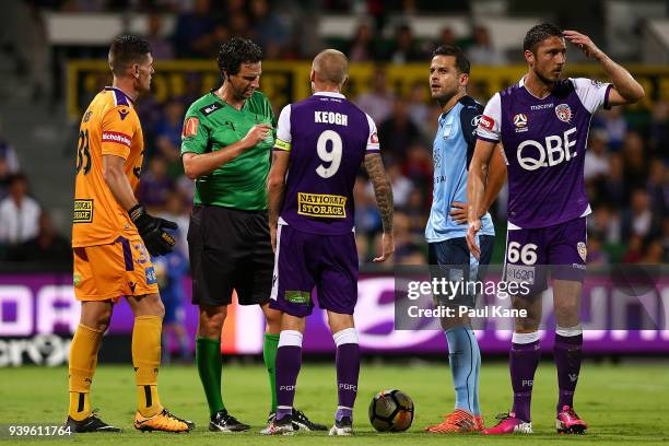 Referee Kris Griffiths-Jones talks with Andy Keogh of the Glory after issueing Dino Djulbic a yellow card during the round 25 A-League match between...