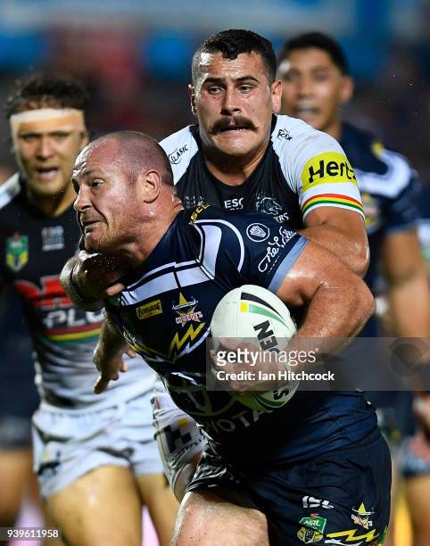 Matthew Scott of the Cowboys is tackled by Reagan Campbell-Gillard of the Panthers during the round four NRL match between the North Queensland...