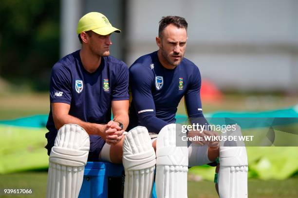 Captain of the South African cricket team, Faf du Plessis and cricketer Theunis de Bruyn take a break during a team practice session on March 29,...