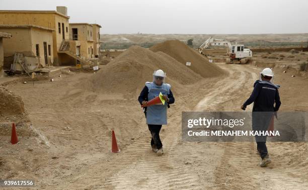 Employees of the HALO Trust, a UK-based non-profit demining organization, place safety funnels on-site at Qasr al-Yahud in the occupied West Bank...