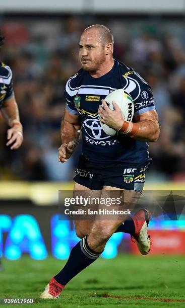 Matthew Scott of the Cowboys runs the ball during the round four NRL match between the North Queensland Cowboys and the Penrith Panthers at...