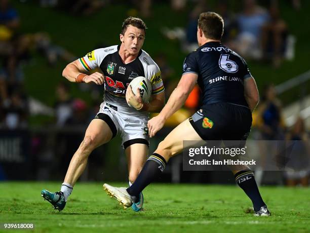 Dylan Edwards of the Panthers looks to get past Michael Morgan of the Cowboys during the round four NRL match between the North Queensland Cowboys...