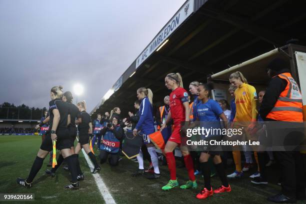 Both teams walk out onto the pitch during the UEFA Womens Champions League Quarter-Final: Second Leg match between Chelsea Ladies and Montpellier at...