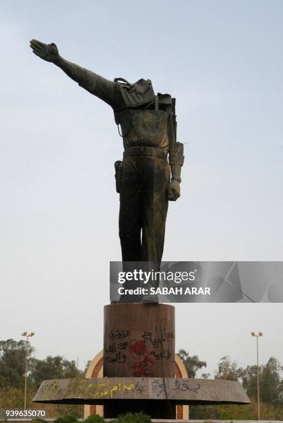 Beheaded statue of toppled Iraqi President Saddam Hussein stands in Baghdad 19 April 2003. Life is slowly returning to normal after the toppling of...
