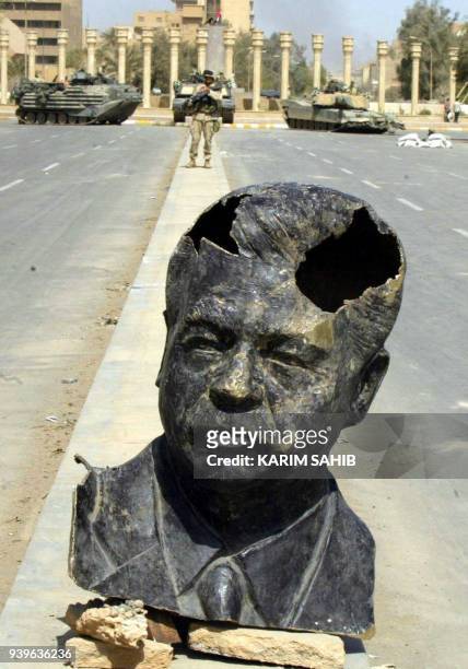 The sculpted head of Saddam Hussein sits in the middle of the street before a US Marines roadblock in Baghdad 10 April 2003. As the regime of Saddam...