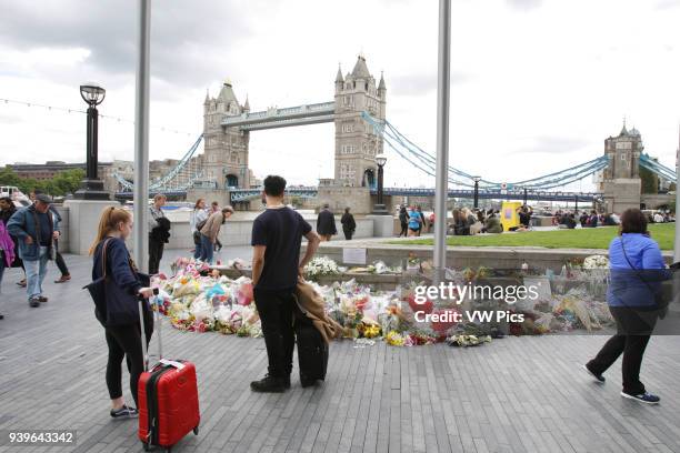 Flowers is placed in front of Tower Bridge at Potters Fields Park outside City Hall in London on June 9, 2017 for those who lost their lives in the...