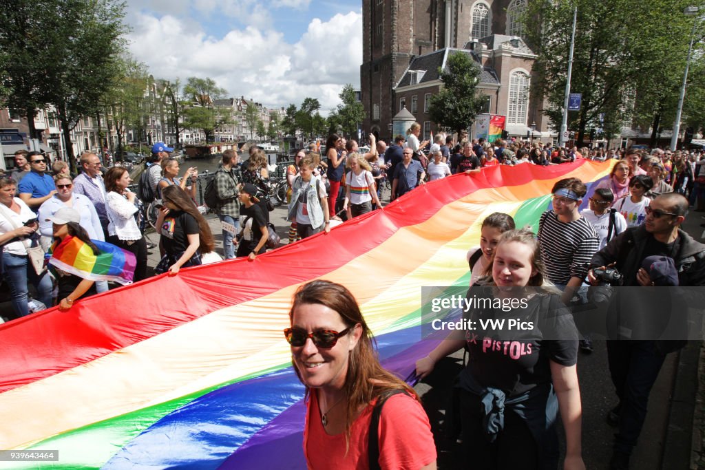 Participants attend the PrideWalk on July 29