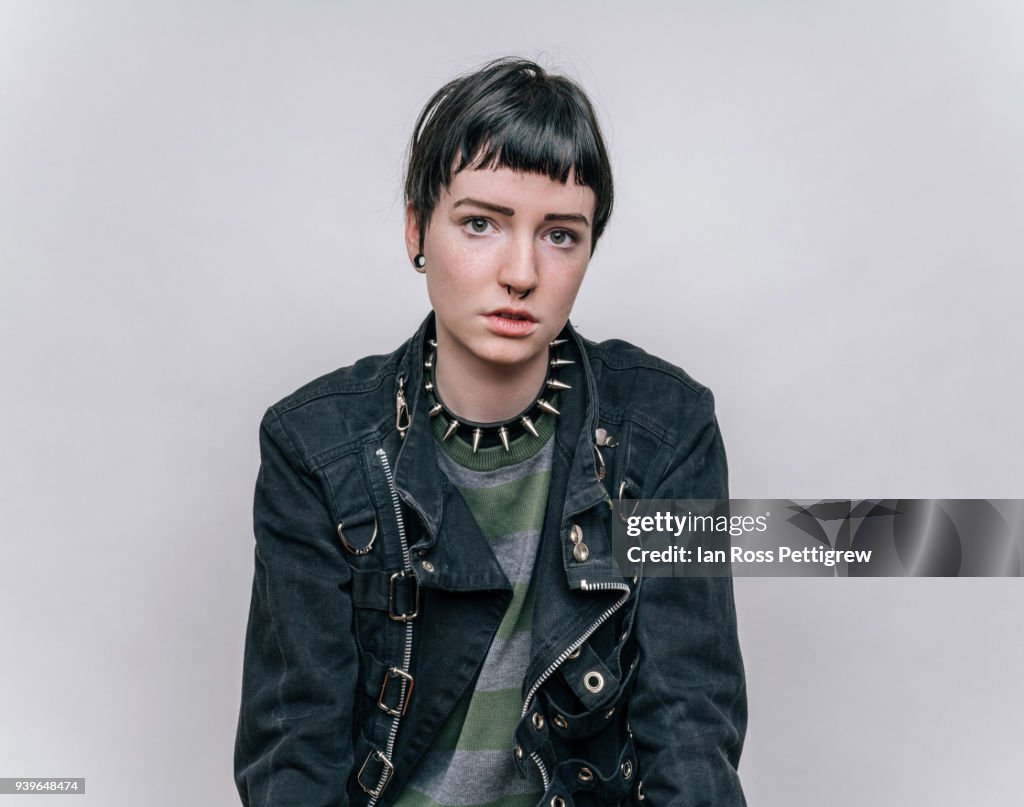 Young punk rock girl in black jacket and jeans