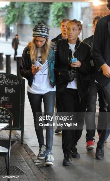 Model Cara Delevingne enjoys a night out with friends at Boom Burger, in Notting Hill on June 3, 2014 in London, England.