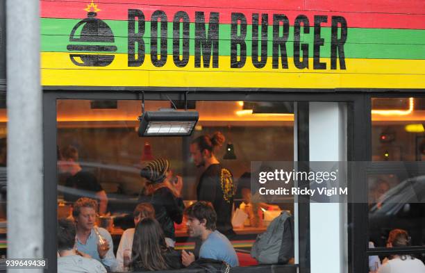 Model Cara Delevingne enjoys a night out with friends at Boom Burger, in Notting Hill on June 3, 2014 in London, England.