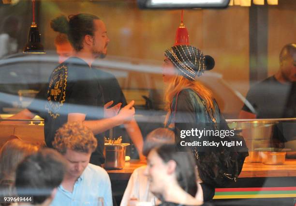 Model Cara Delevingne enjoys a night out with friends at Boom Burger, in Notting Hill on June 3, 2014 in London, England.