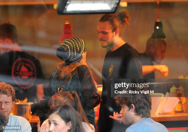 Model Cara Delevingne enjoys a night out with friends at Boom Burger, in Notting Hill on June 3, 2014 in London, England.