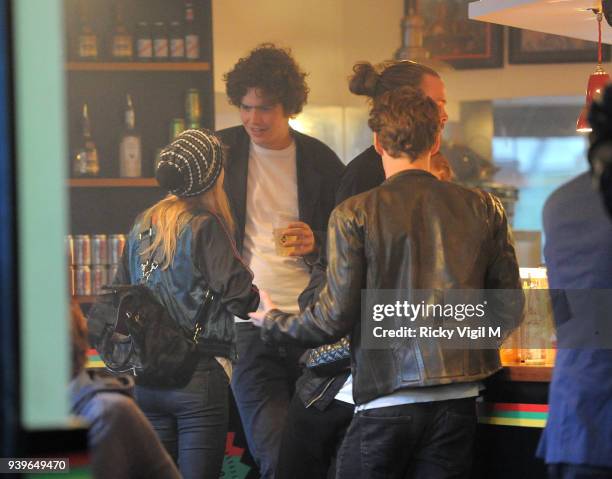 Model Cara Delevingne enjoys a night out with friends at Boom Burger, in Notting Hill on June 3, 2014 in London, England.