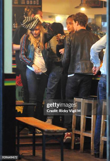 Model Cara Delevingne enjoys a night out with friends at Boom Burger, in Notting Hill on June 3, 2014 in London, England.